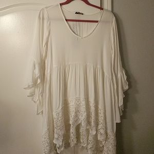 White flowy bell sleeved top